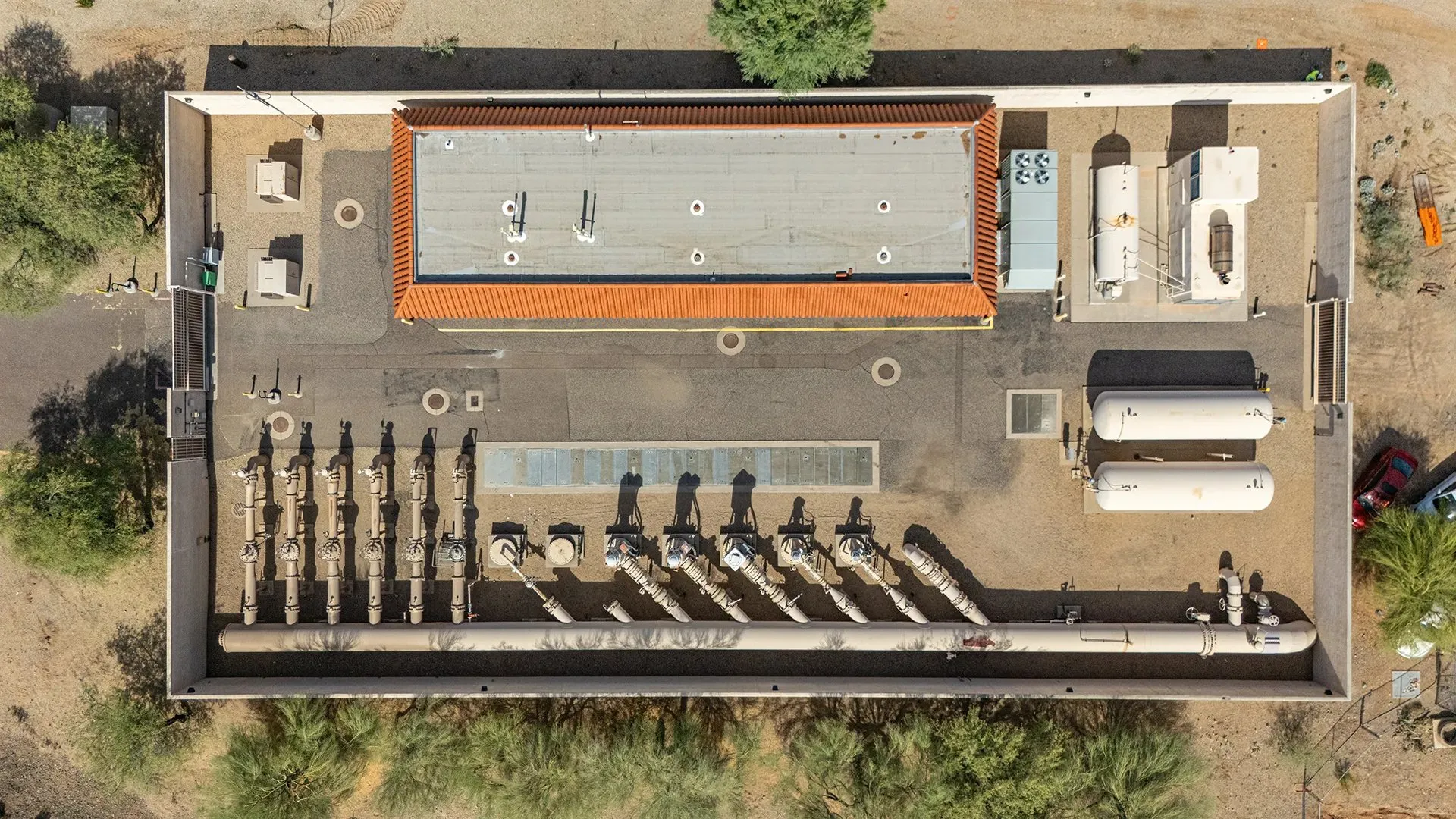 Top-down drone photo of an industrial facility and its equipment yard